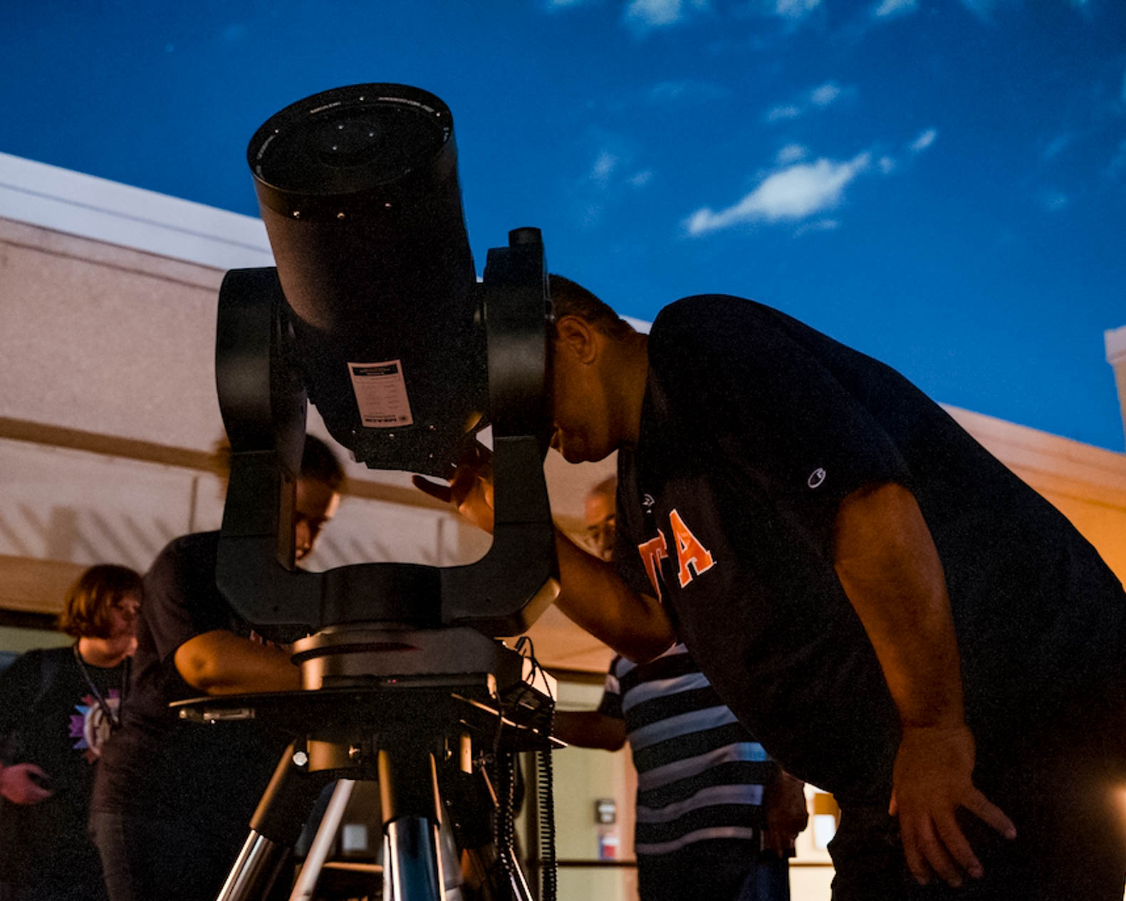 Student looking through a telescope